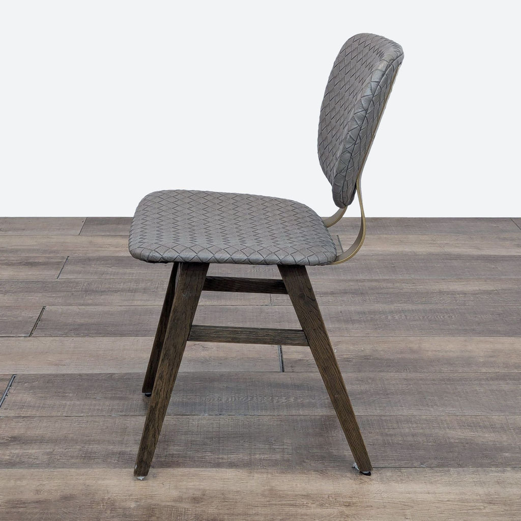 Four Hands dining chair: grey quilted faux leather seat, brass details, and honey oak wooden legs.