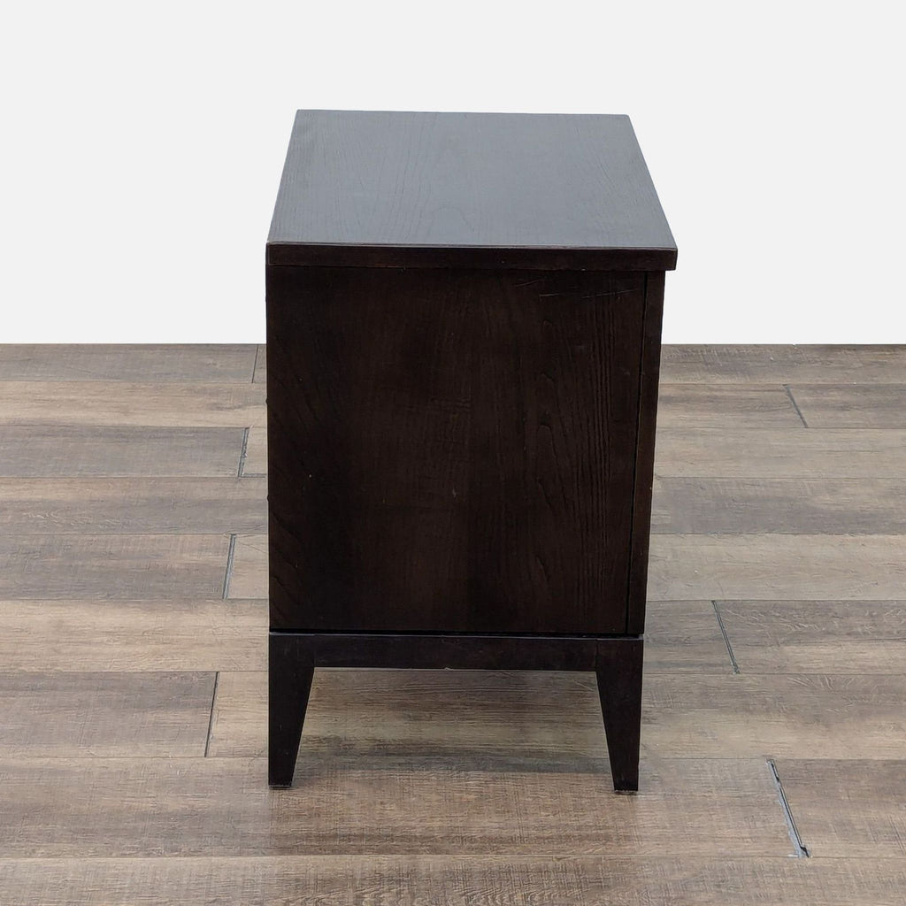 a wooden table with a black and white rug 