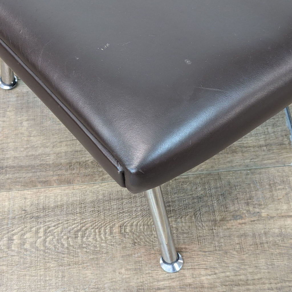 a black leather chair with a black handle 