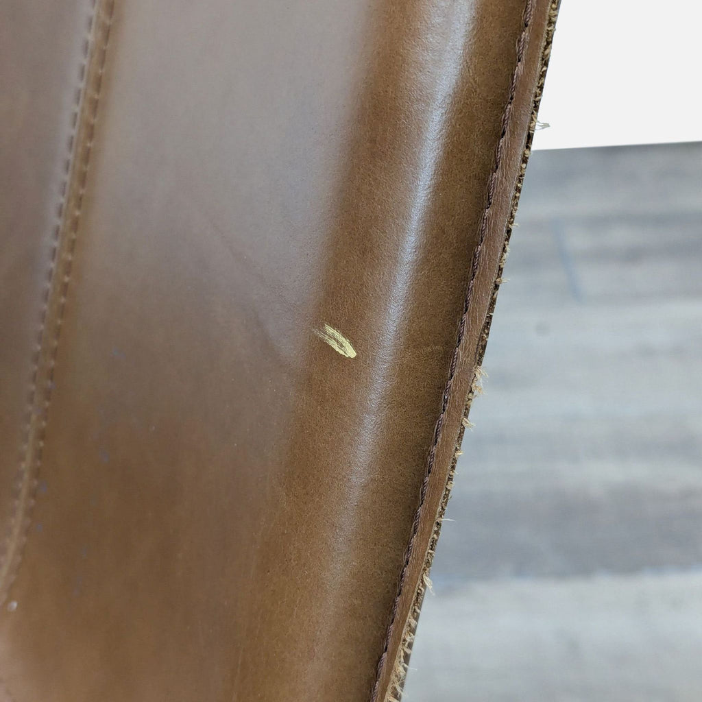 a brown leather suitcase sitting on a wooden floor 