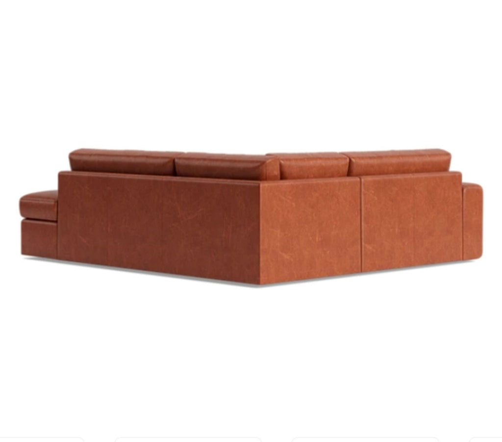 3. Rear angle showing the oversized, rounded silhouette of the leather OG Couch Potato sectional from Benchmade Modern.