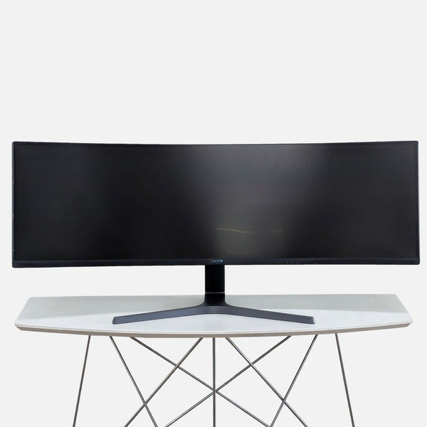 a computer desk with a monitor and keyboard 