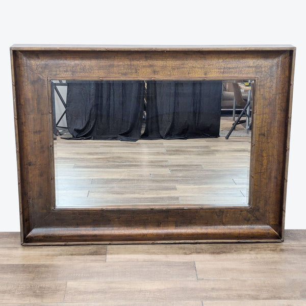 a mirror with a wooden frame and a wooden chair 