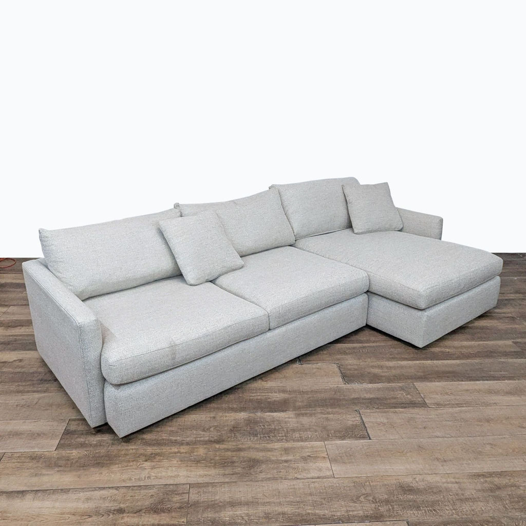 a white couch sitting on top of a wooden floor 