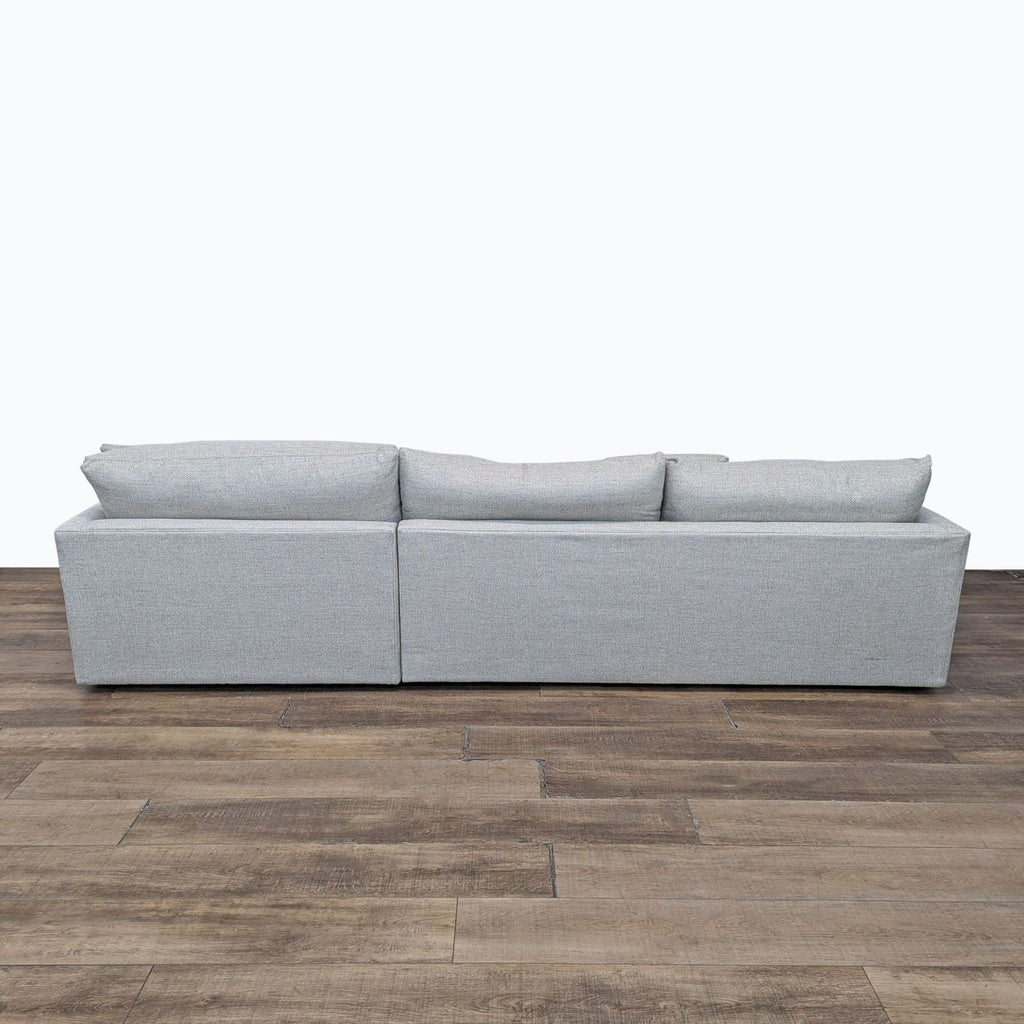 a white couch sitting on top of a wooden floor 