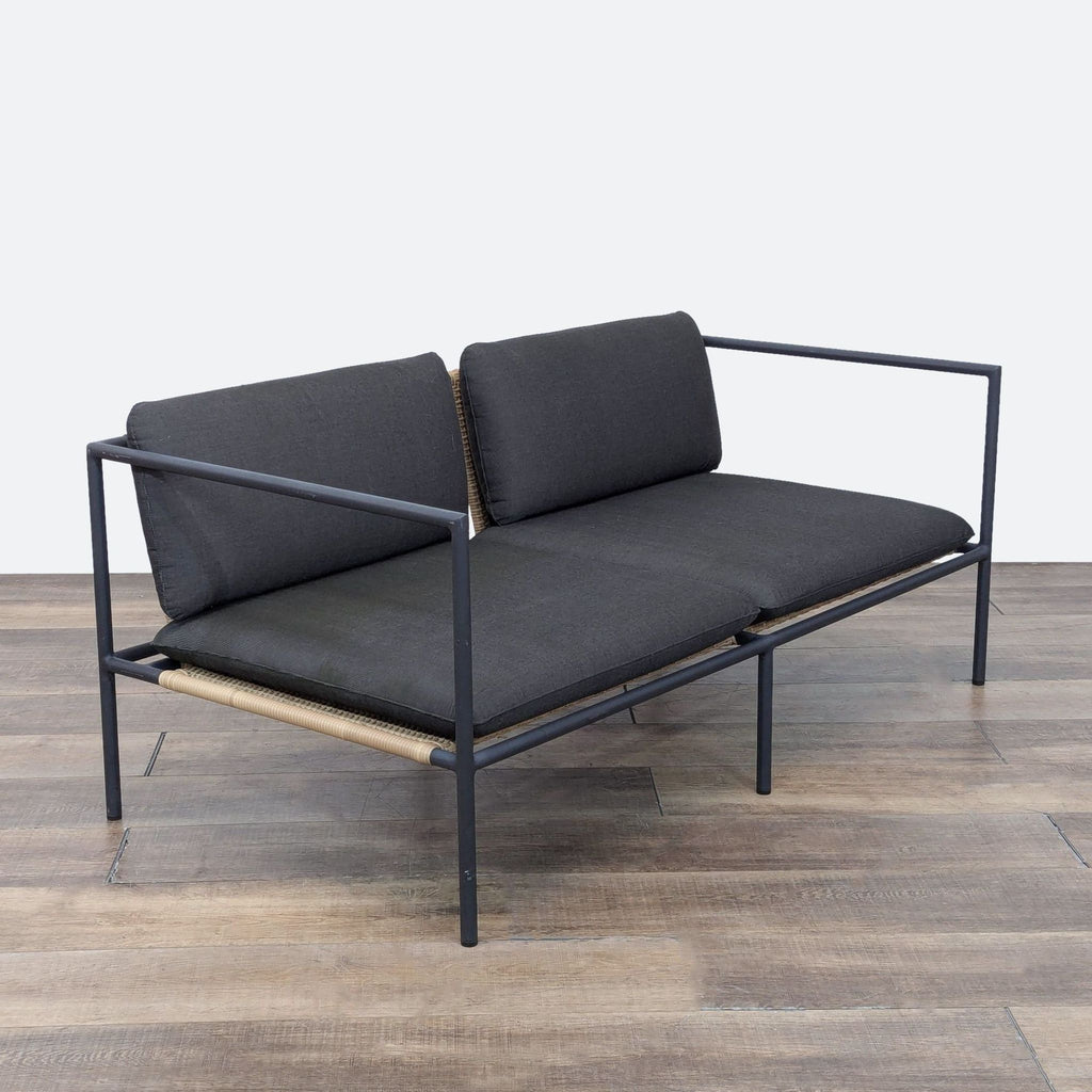 a couch with a black leather couch cushion 