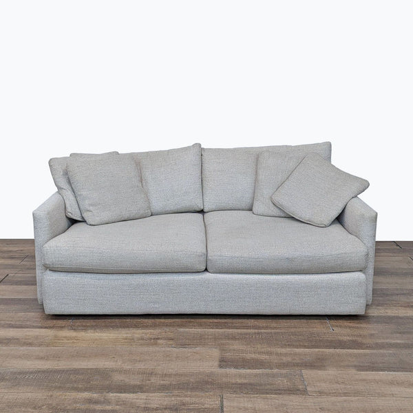 a white couch with a black couch cushion 