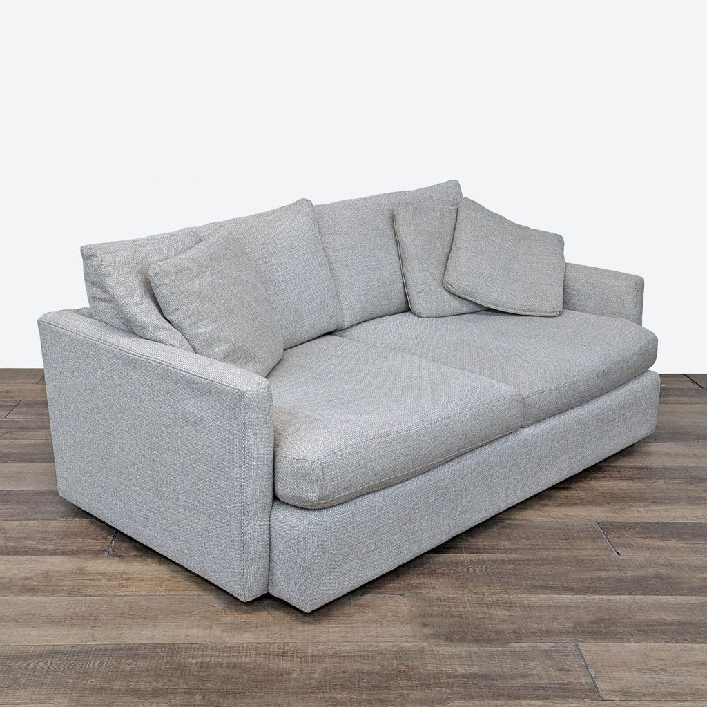 a white couch with a black couch cushion 