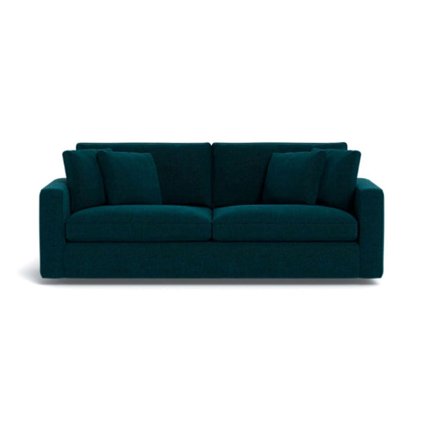 a white couch with a blue couch cushion 