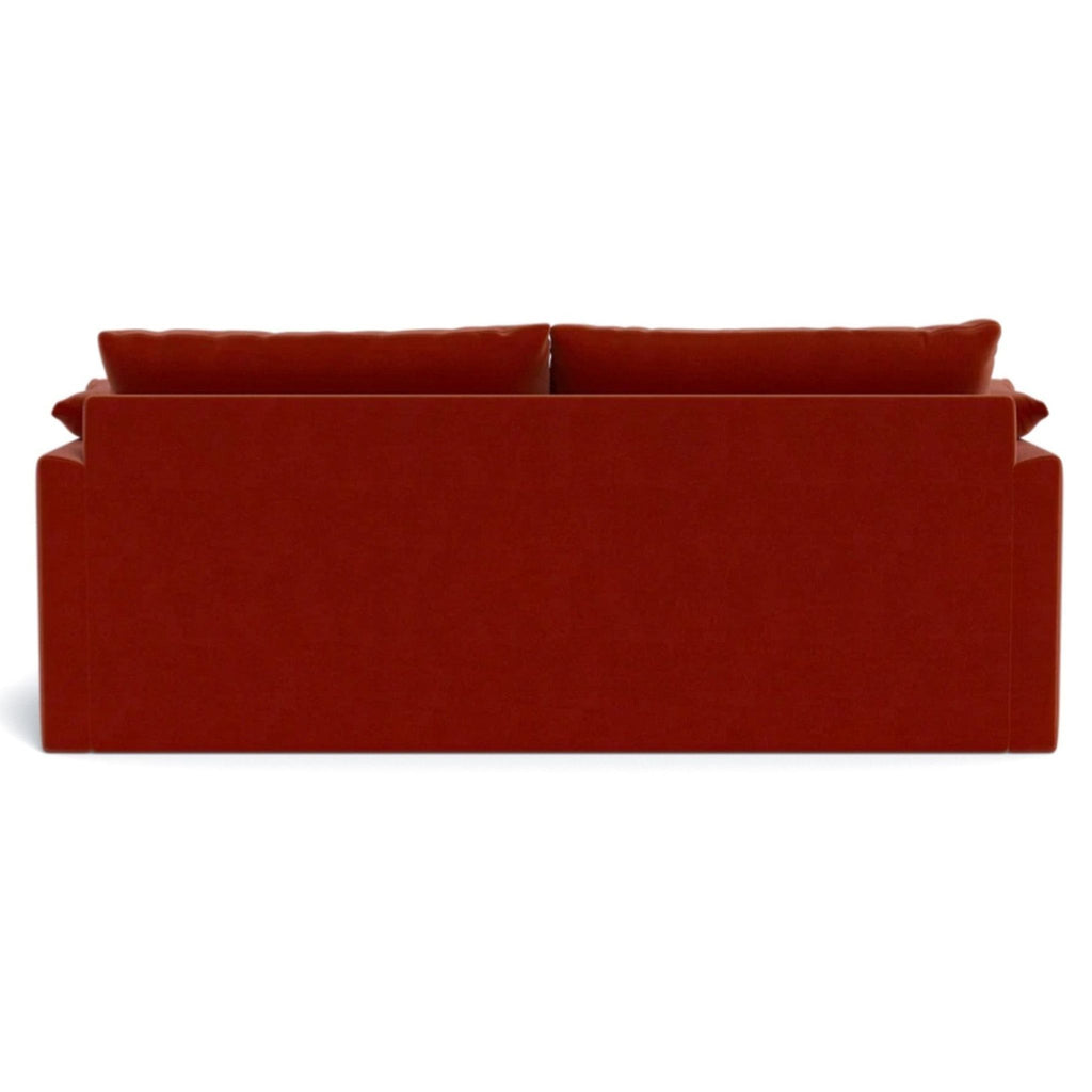 a red couch with a red cover on it 