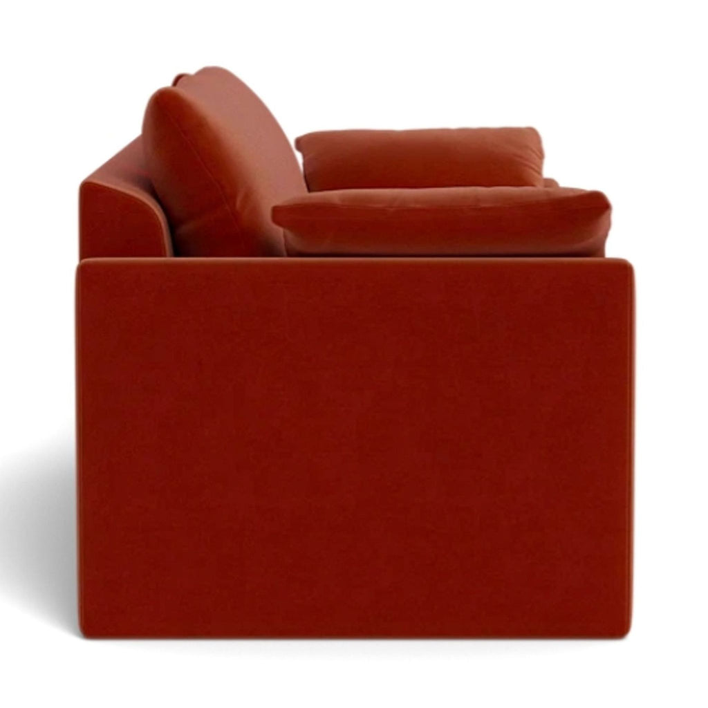 a red couch with a red cushion and a red chair 