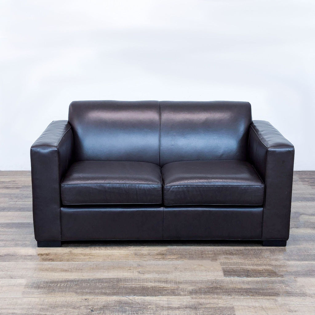 a black leather couch with a black leather seat 