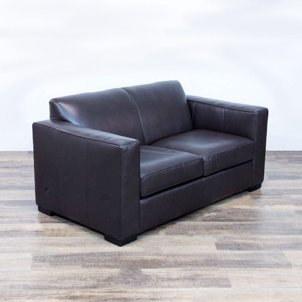 a black leather couch with a black leather seat 