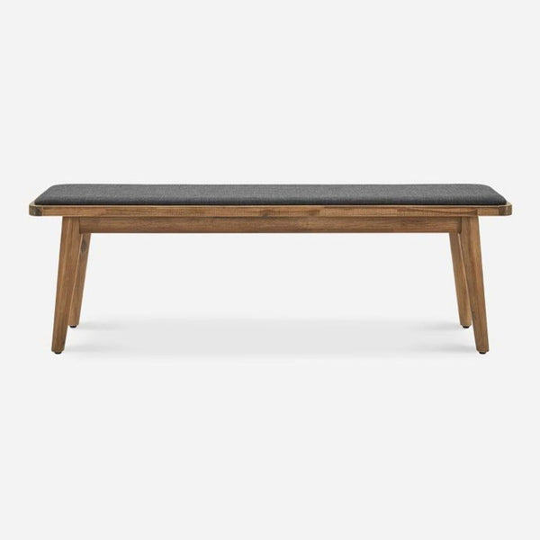 a bench is sitting on a wooden surface 