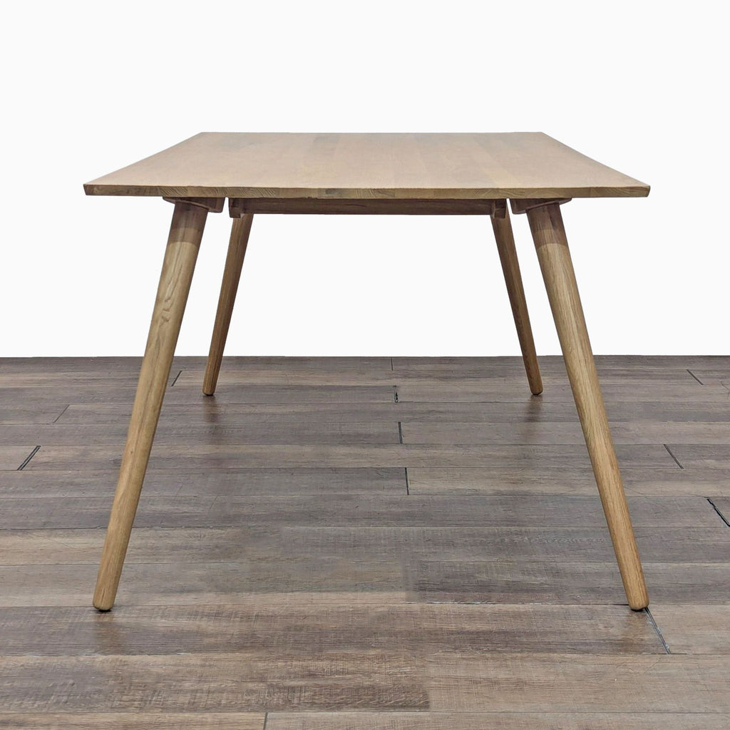 a wooden table with a wooden chair on top of it 