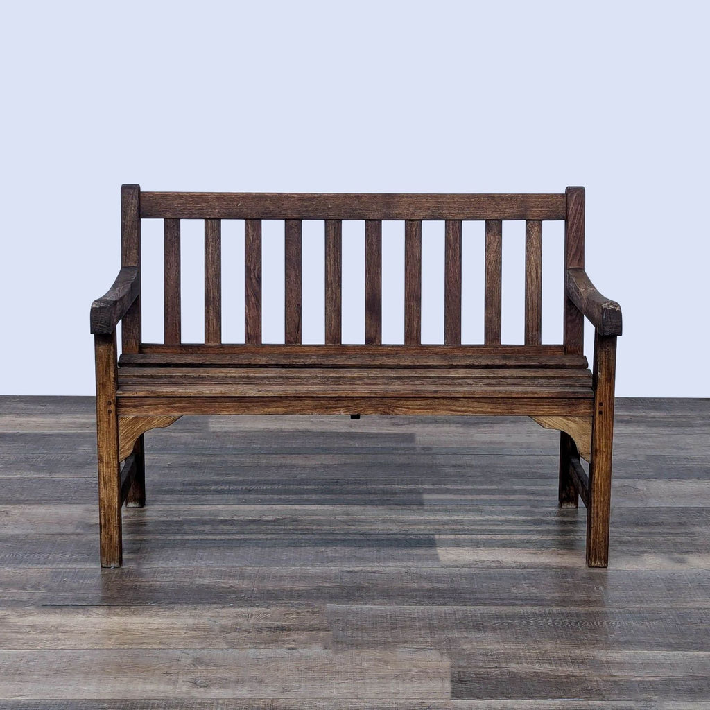 a wooden bench sitting on top of a wooden floor 
