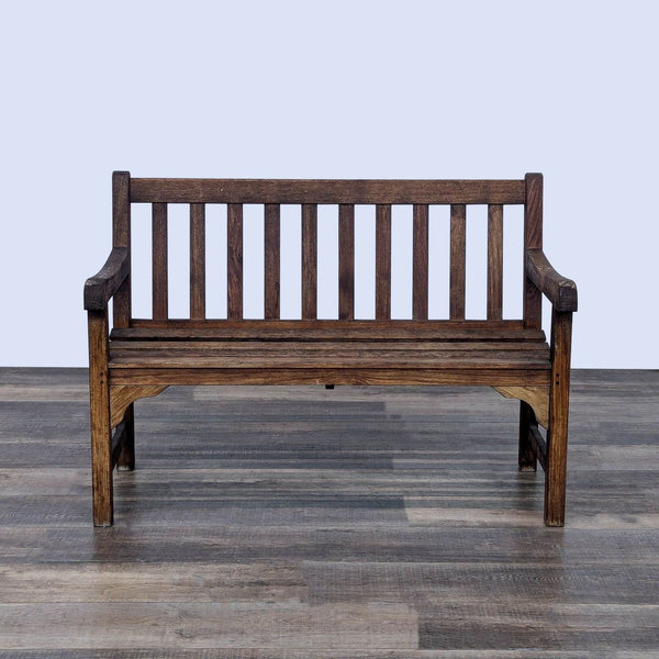 a wooden bench sitting on top of a wooden floor 