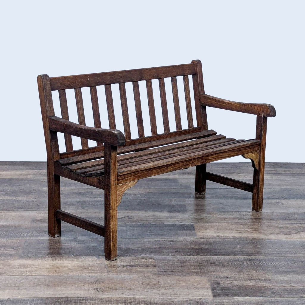 a wooden bench sitting on top of a floor 