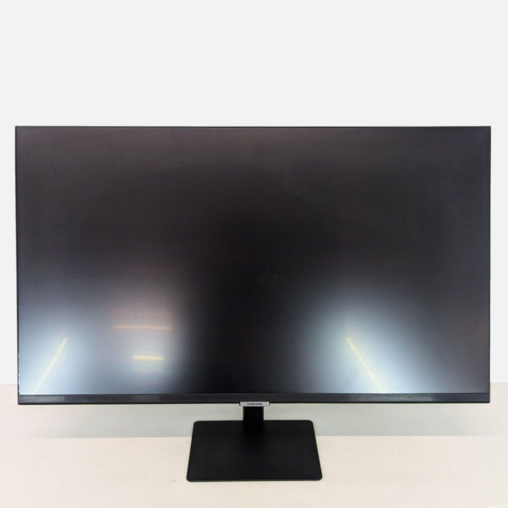 a computer monitor sitting on top of a desk 