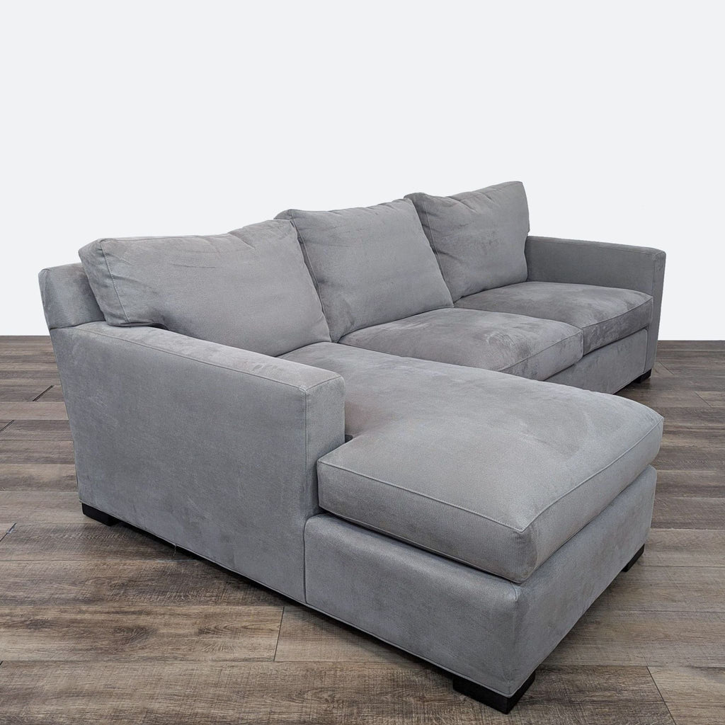 a couch with a black leather couch cushion 