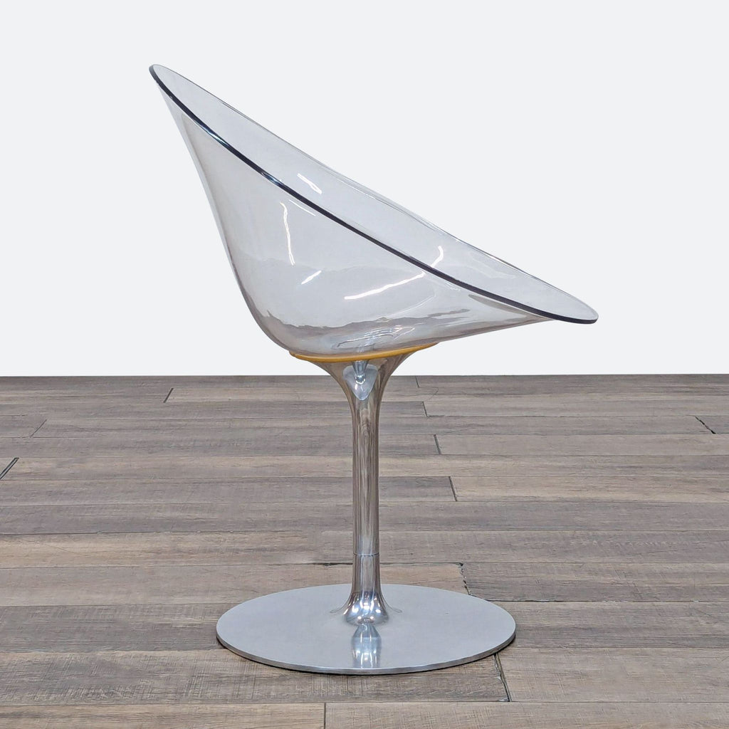 2. Modern Kartell lounge chair in side profile, showing its transparent egg-shaped seat and central metal support.