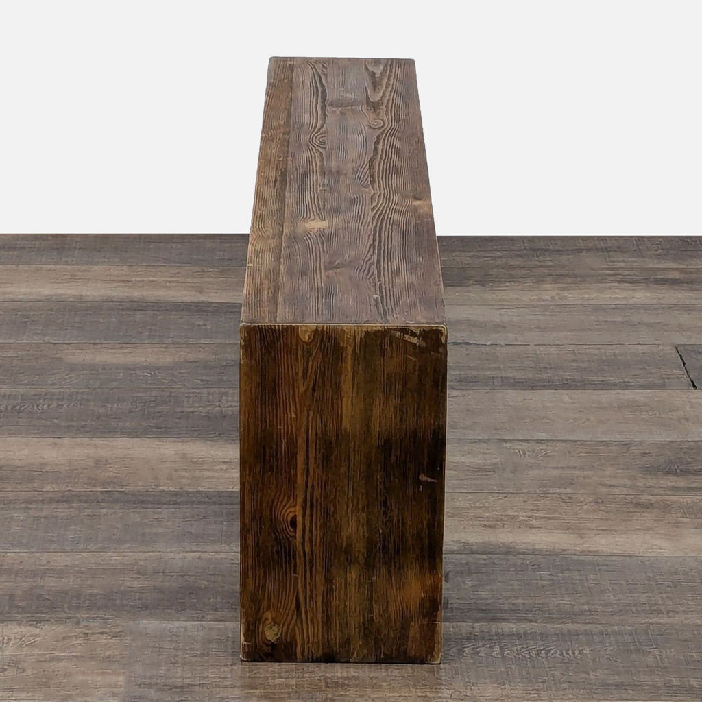 a wooden bench with a wooden handle on top 