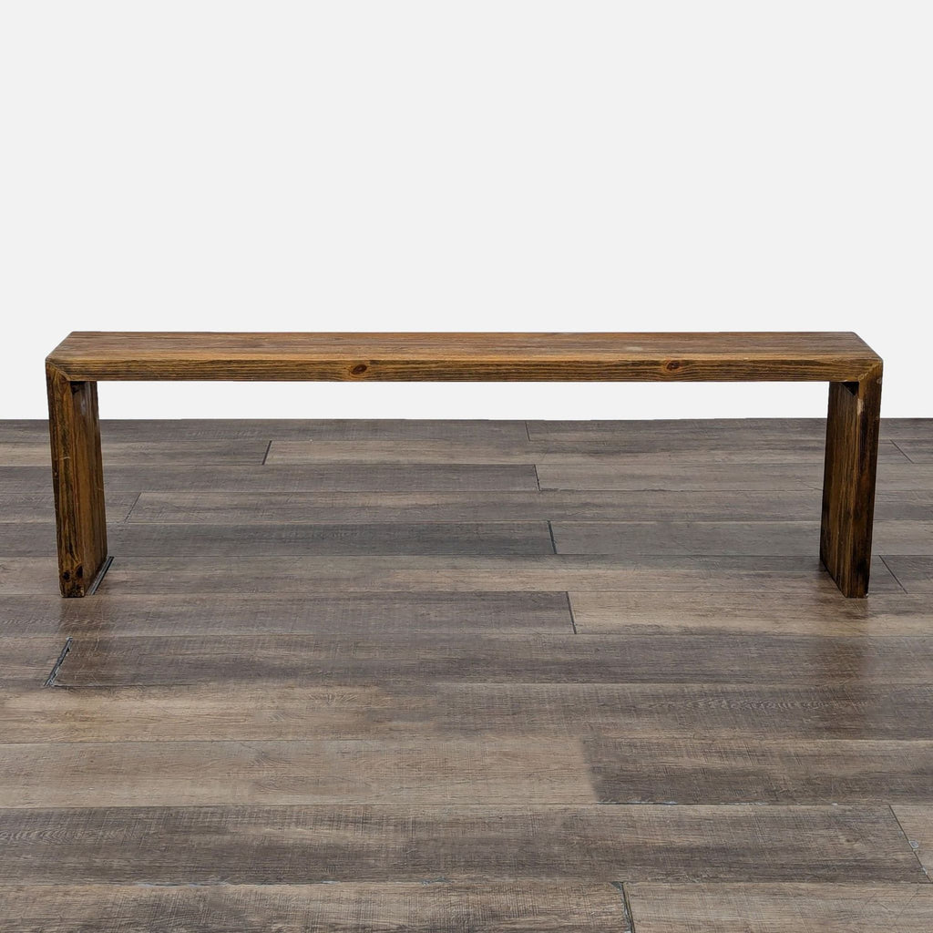 a wooden bench sitting on top of a wooden floor 