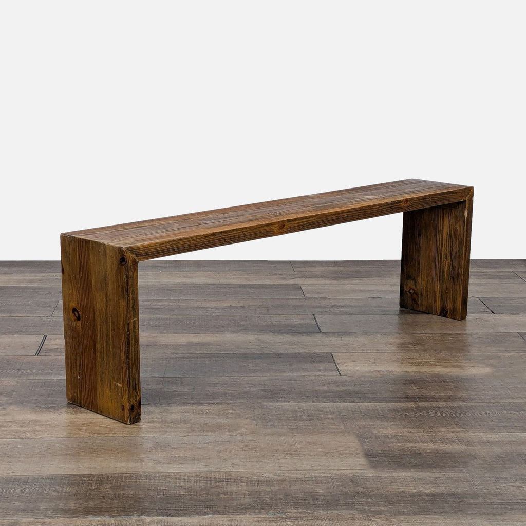 a wooden bench sitting on top of a wooden floor 