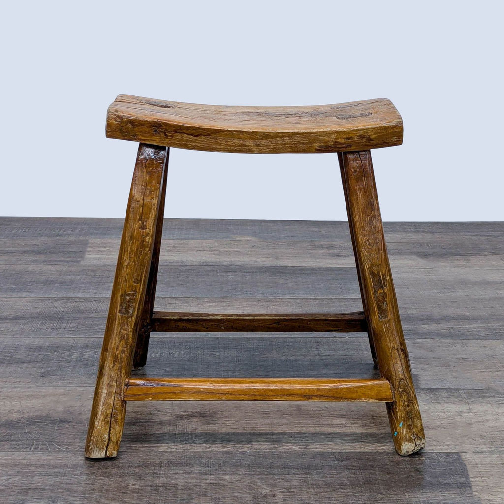 a wooden chair with a wooden foot on it 