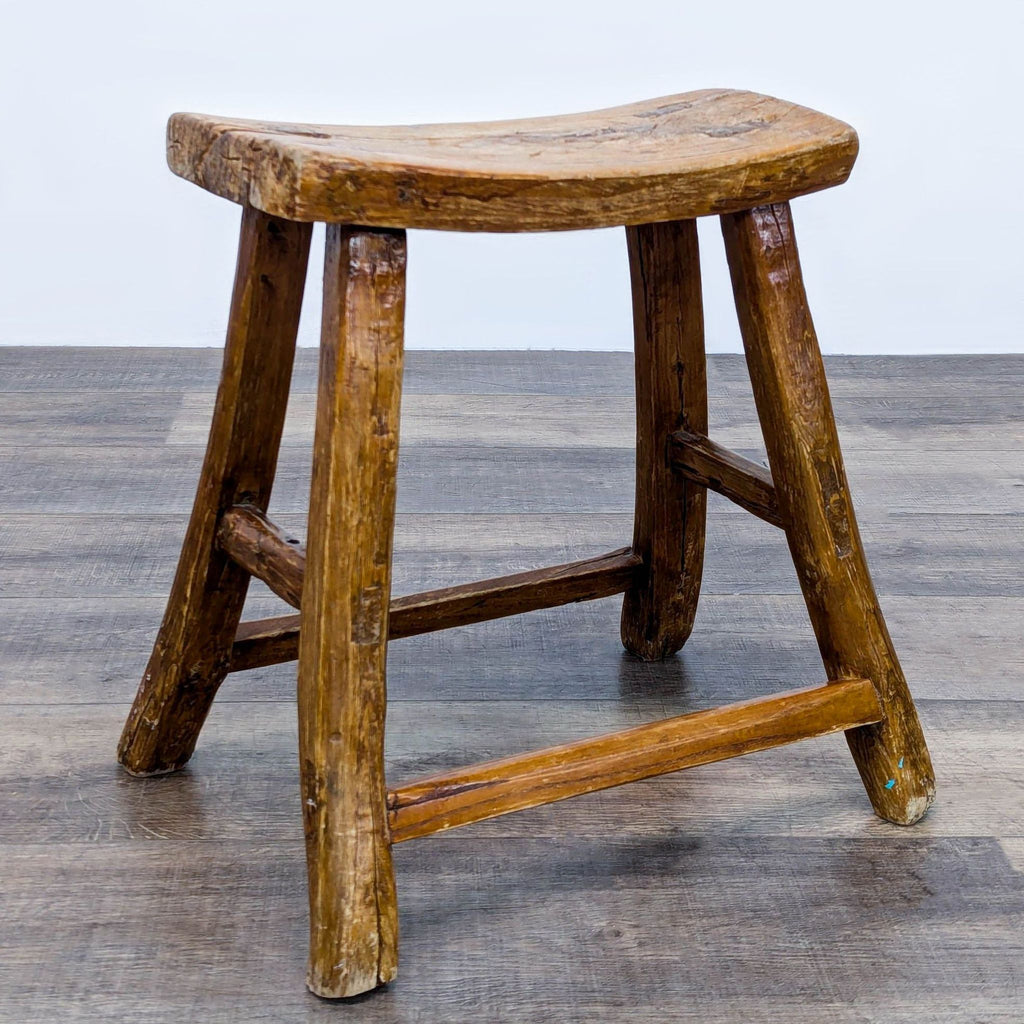 a wooden chair sitting on top of a wooden floor 