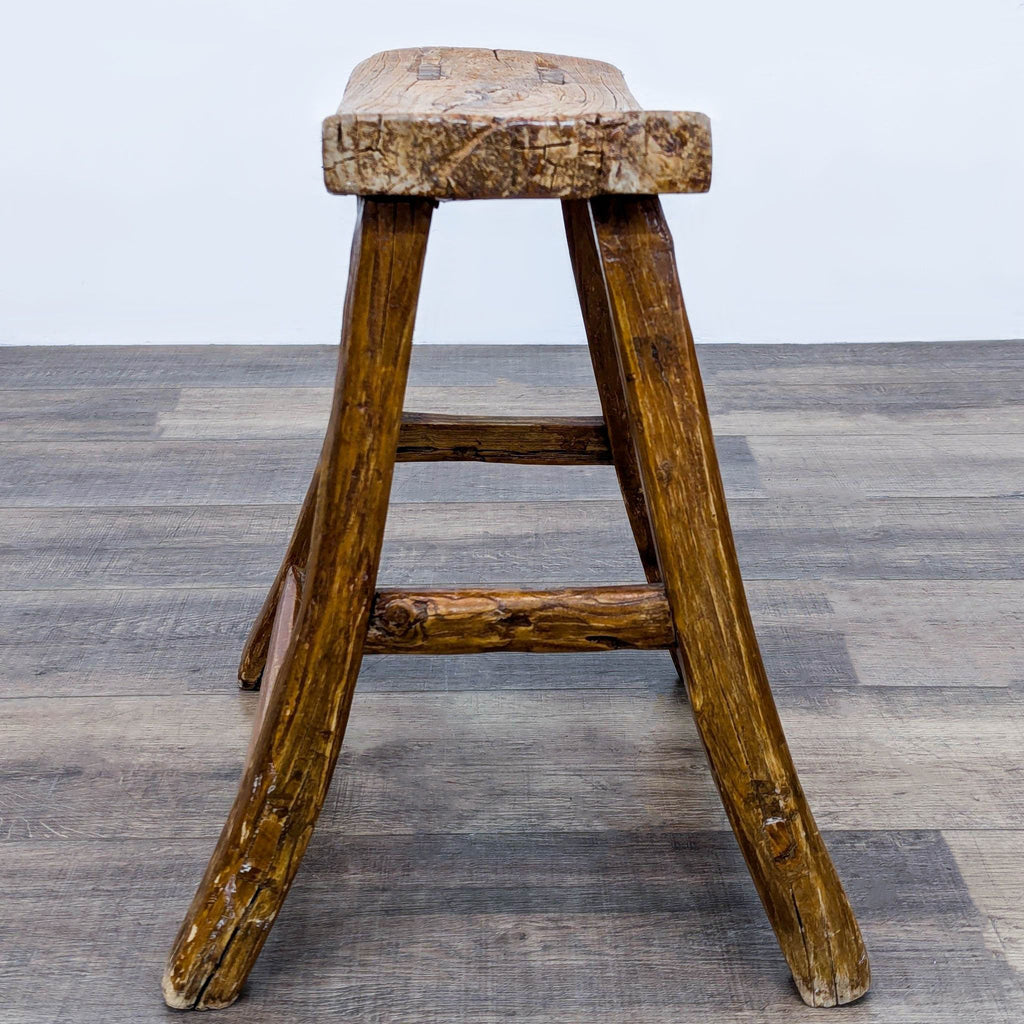 a wooden chair sitting on top of a wooden floor 