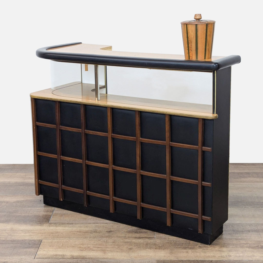 a wooden table with a wooden chair and a vase 