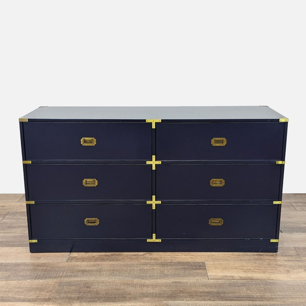 a wooden cabinet with a pair of black shoes on top 