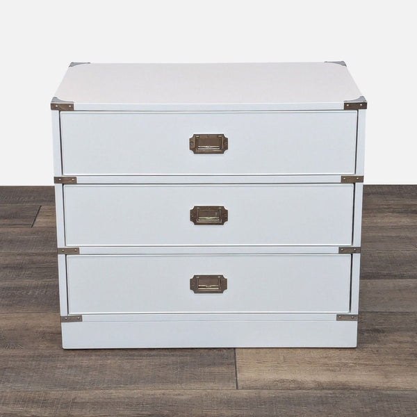 a white cabinet with a black and white striped door 