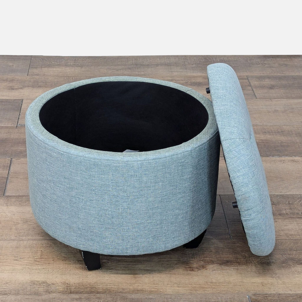 a black couch with a black handle and a blue umbrella 