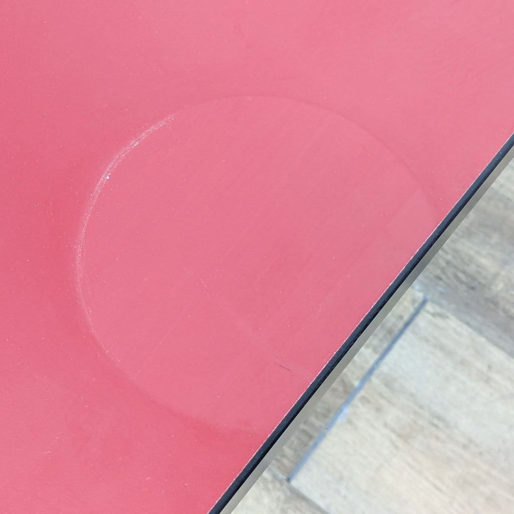a red and white object sitting on top of a red surface 