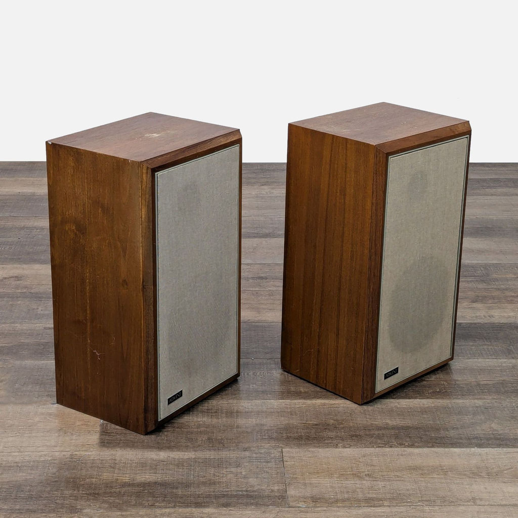 two wooden boxes with wooden handles on a floor 