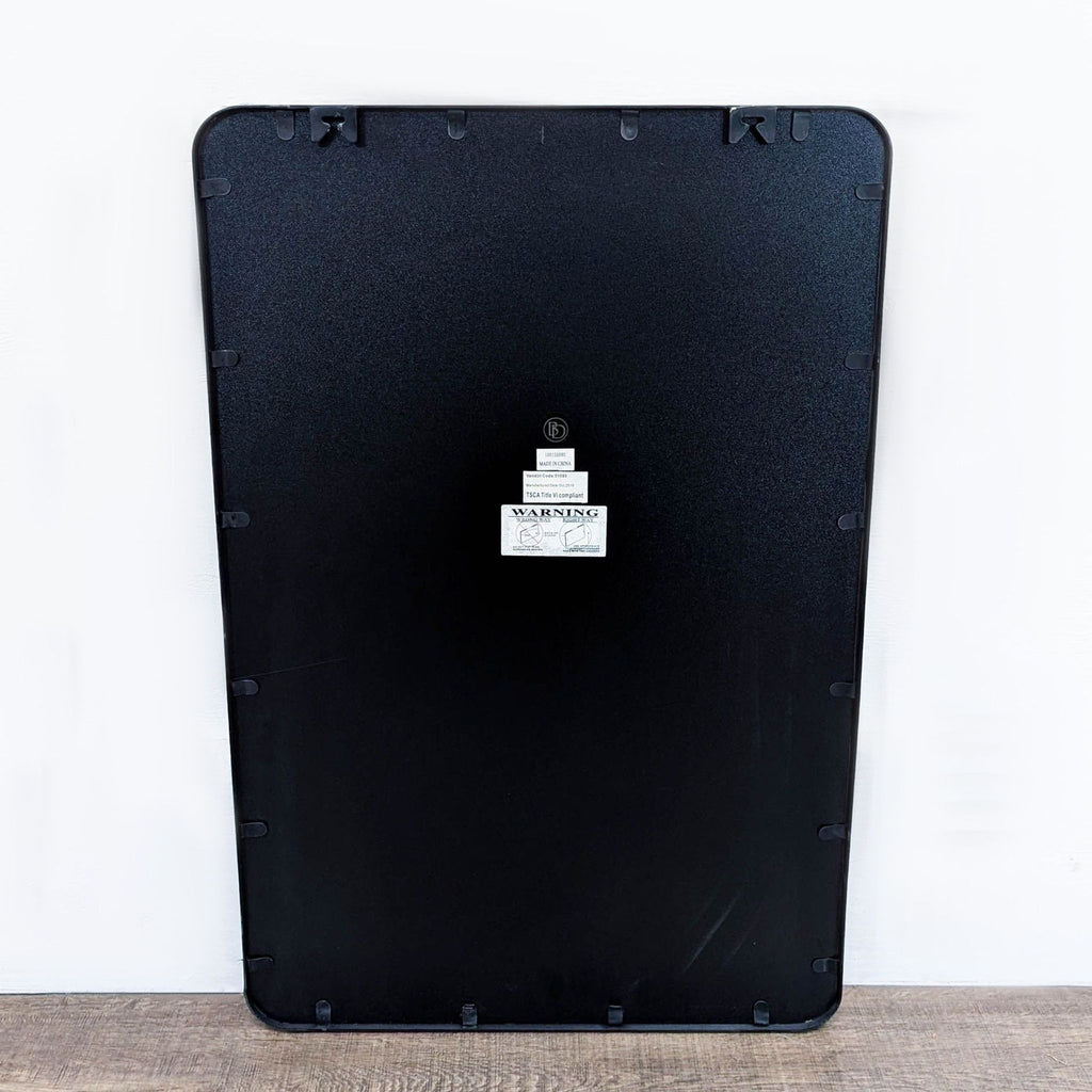 a black and white computer mouse sitting on a white surface 