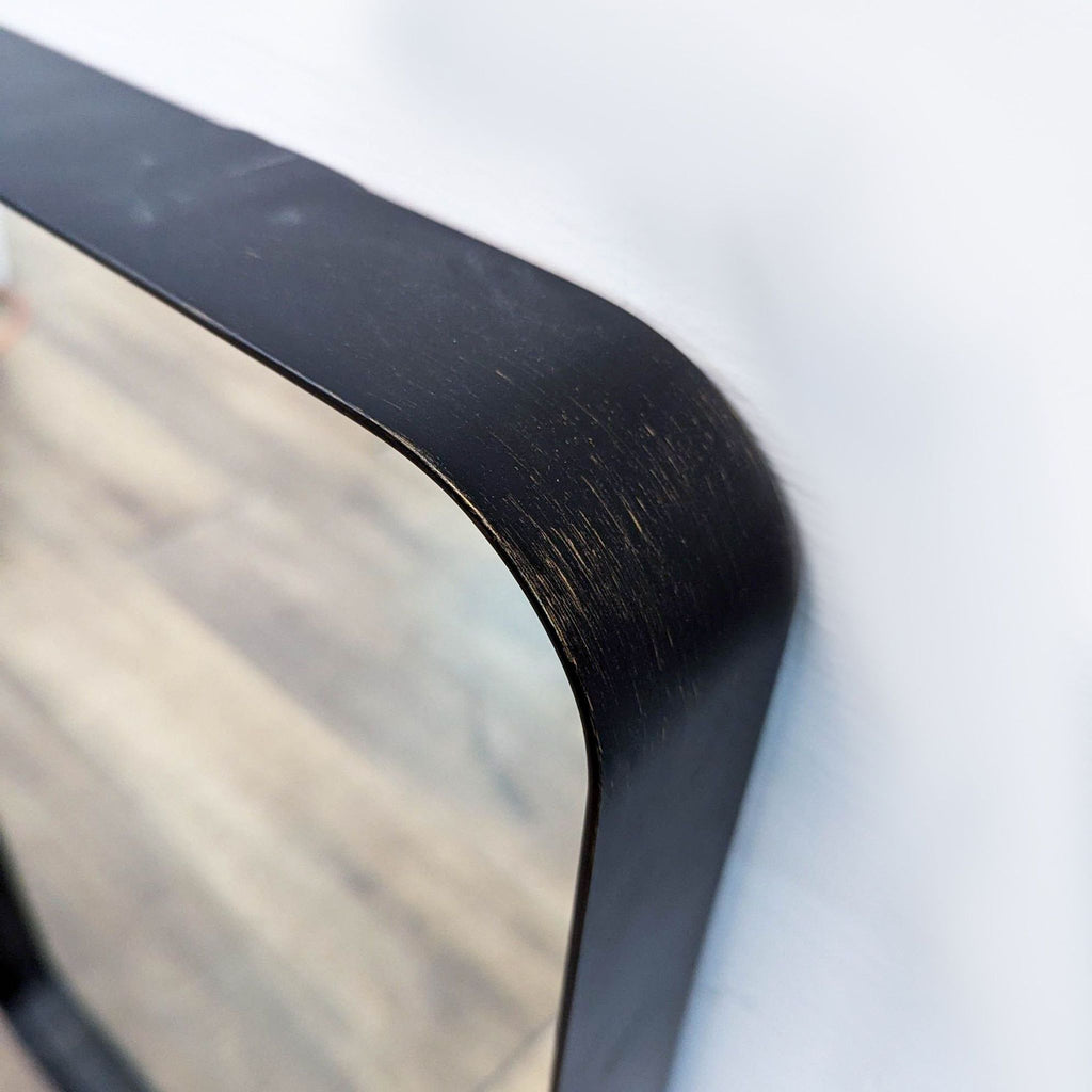 a mirror on a table with a picture of a person 