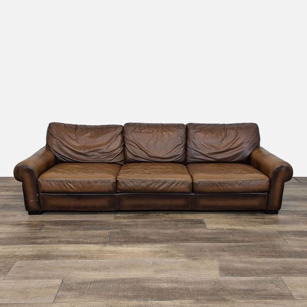 a couch with a brown leather couch cushion 