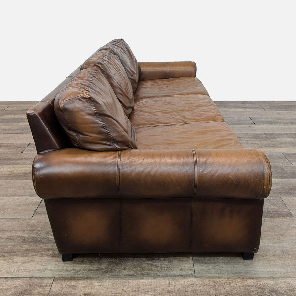 a couch with a brown leather couch cushions and a black leather couch cushion 