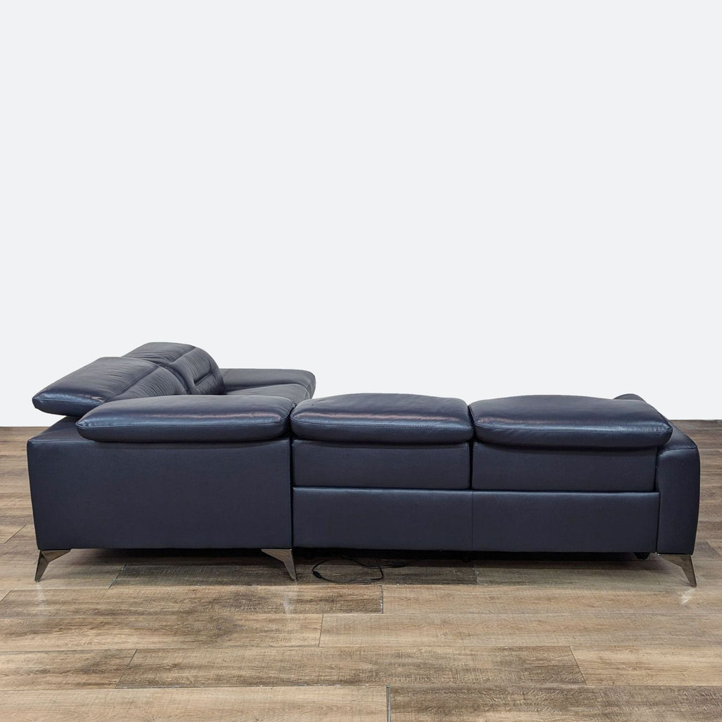 3. Side view of Reperch navy leather sectional with power recliners extended and adjustable headrests.