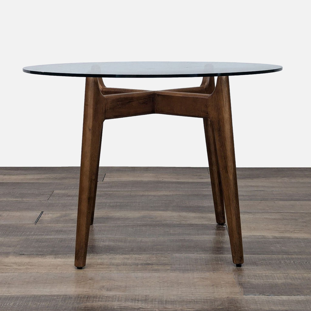 a wooden table with a chair and a table cloth 