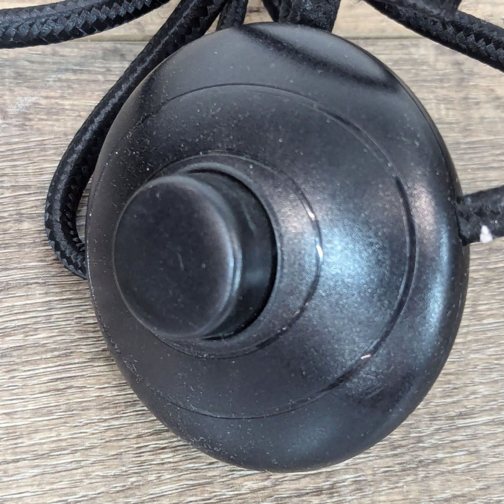a black and white toy mouse sitting on a wooden surface 