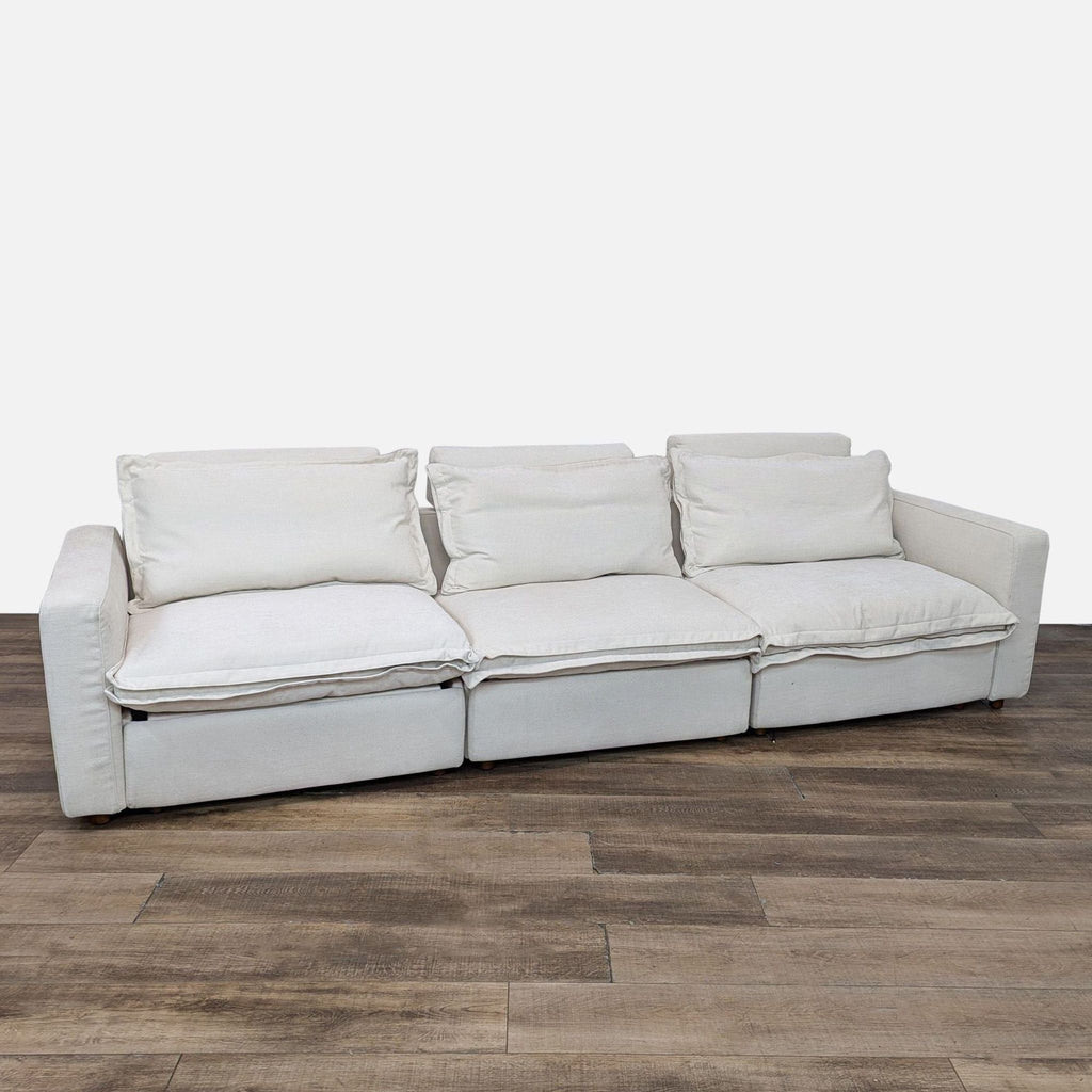 a white couch with a white couch cushion on it 