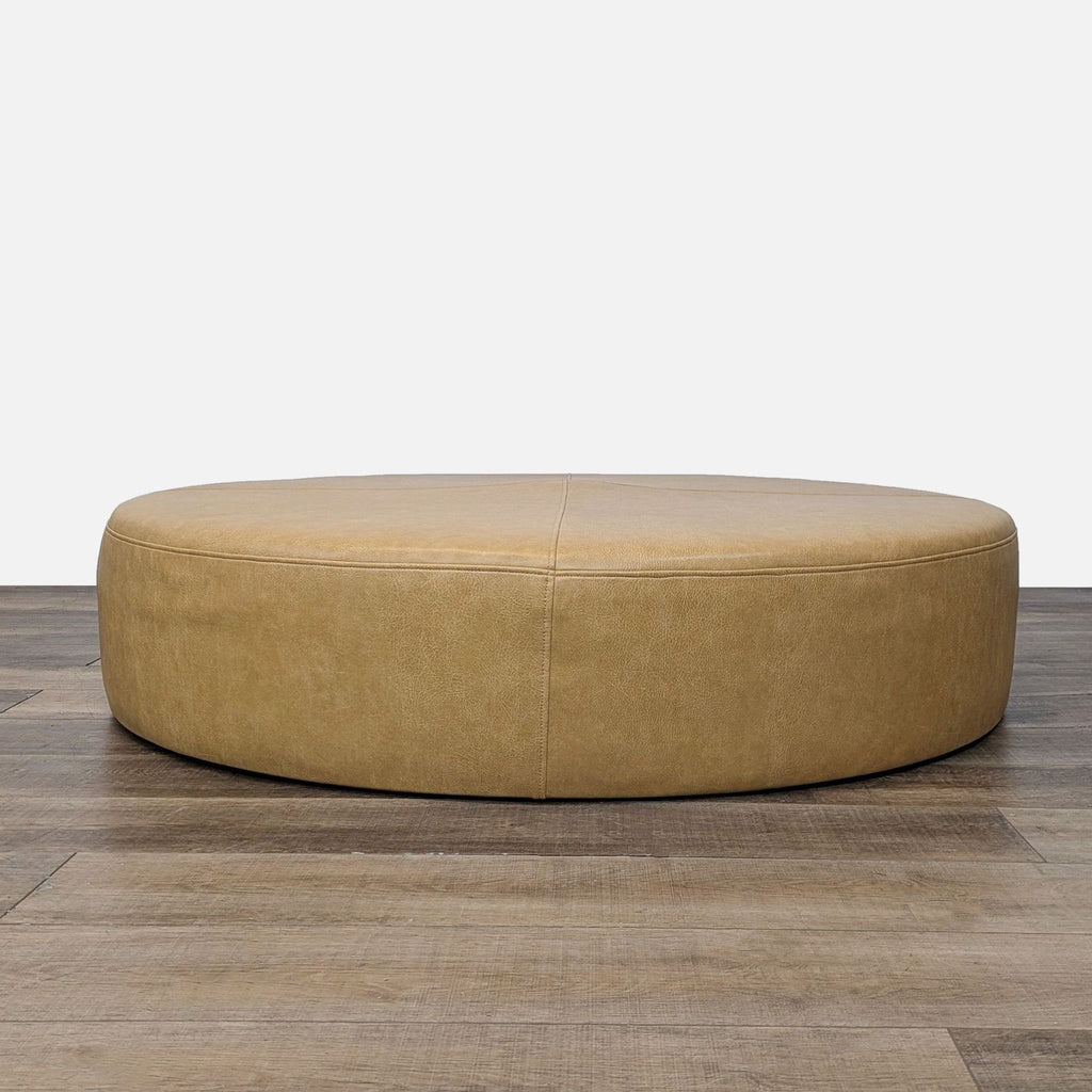 a brown leather shoe sitting on a wooden floor 