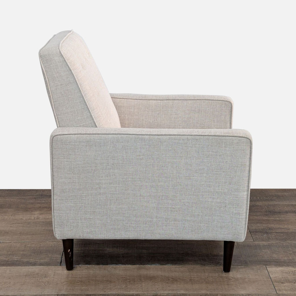 a white chair with a black cushion on it 