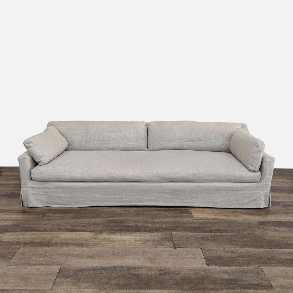 a white couch sitting on top of a hard wood floor 