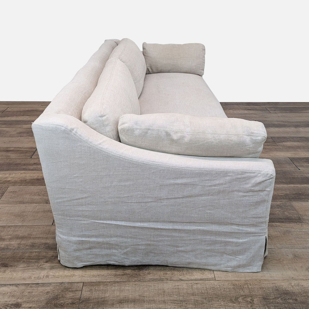 a white couch with a black cushion on it 