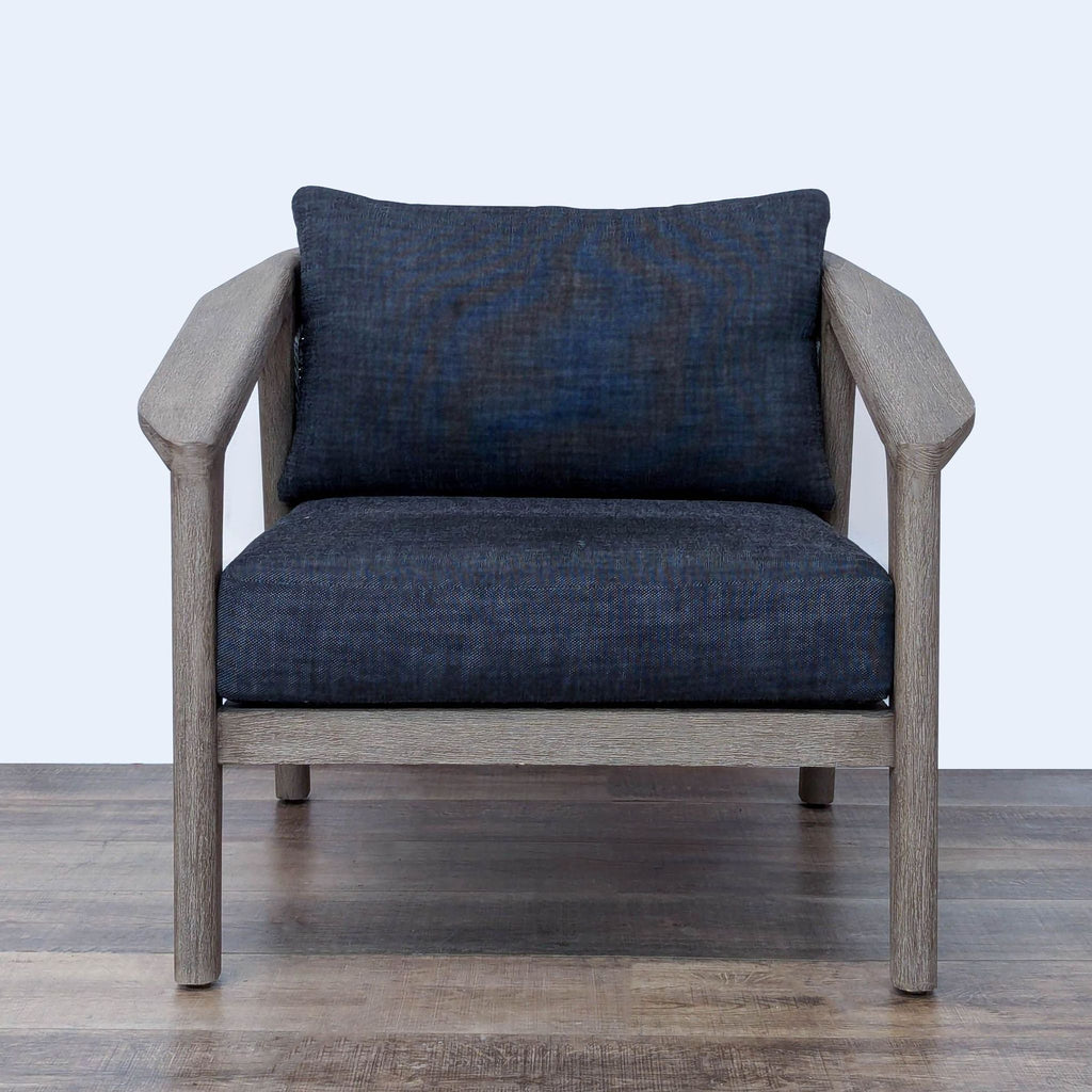 Restoration Hardware Malta lounge chair crafted of weathered teak, wicker basket weave, and quick-dry upholstered cushions.